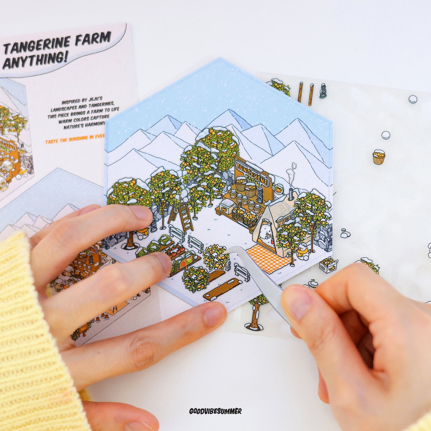A child's hands placing stickers to create a miniature room.